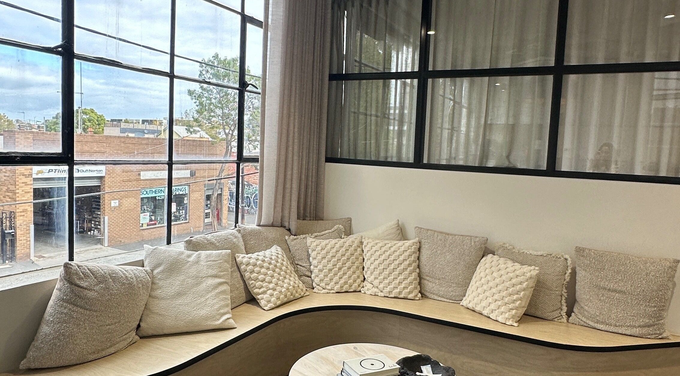 Inviting window seating with plush cushions at Studio April, Melbourne, Victoria, AU offering cozy relaxation.