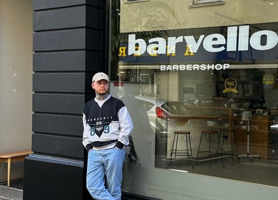 Barvello Barbershop exterior view in Saint Helier, St Helier, JE with a stylish person standing outside.