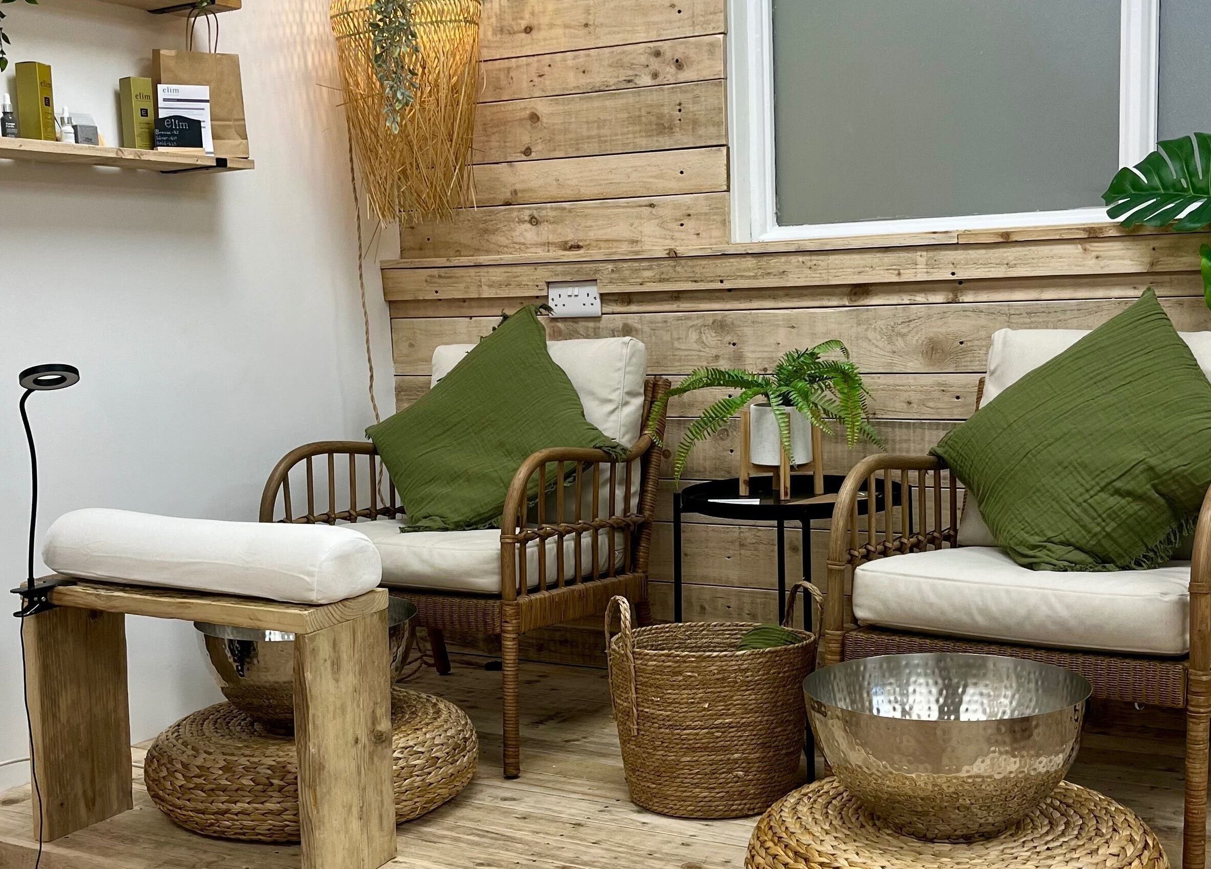 Inviting seating area at Perfectpedi With Frenchies, Pembroke, Cymru, GB with cozy chairs and greenery.