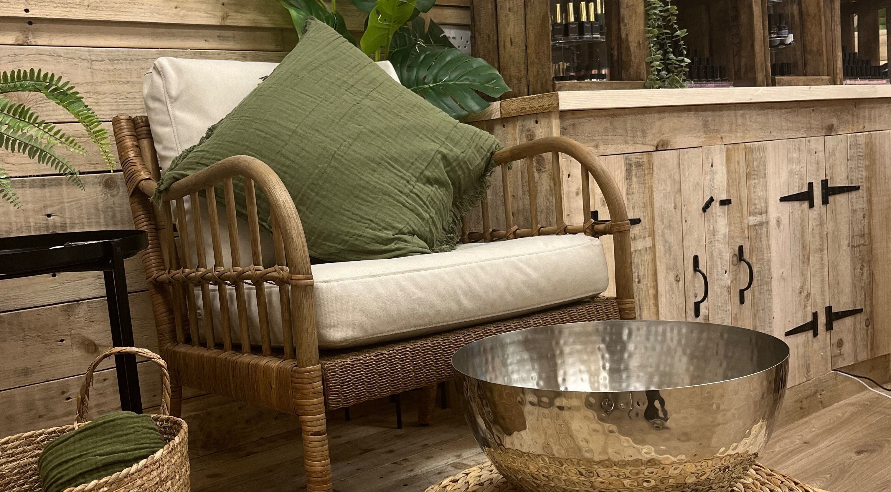 Cozy seating area at Perfectpedi With Frenchies in Pembroke, Cymru, GB, featuring a wicker chair and green cushion.