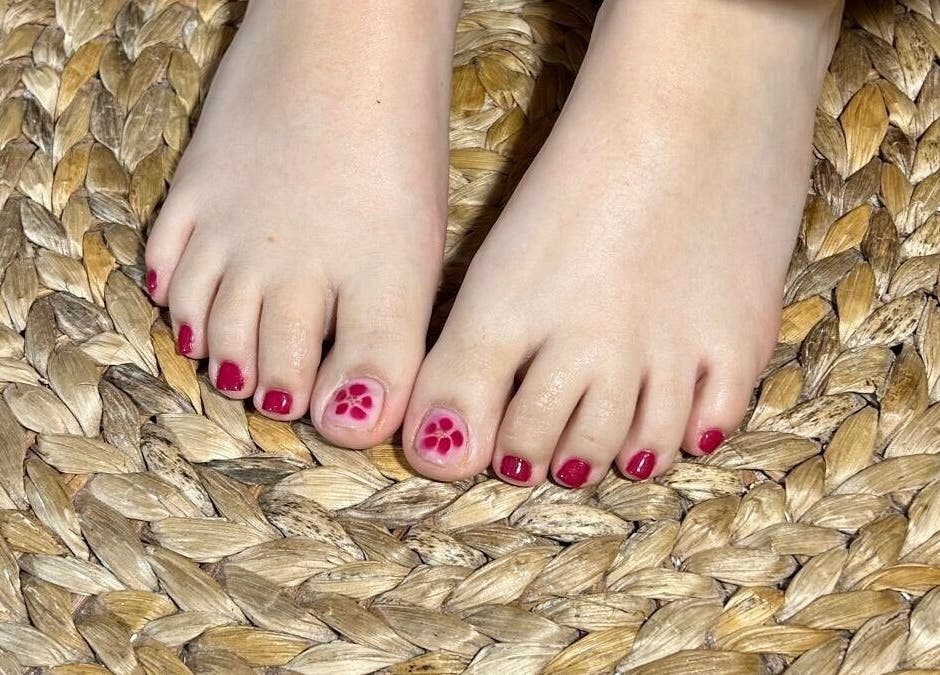 Beautiful pedicure with floral art at Perfectpedi With Frenchies, Pembroke, Cymru, GB on woven mat.