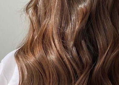 Luxurious wavy brown hair styled at Glow Beauty, Elgin, Scotland, GB for a flawless, elegant look.