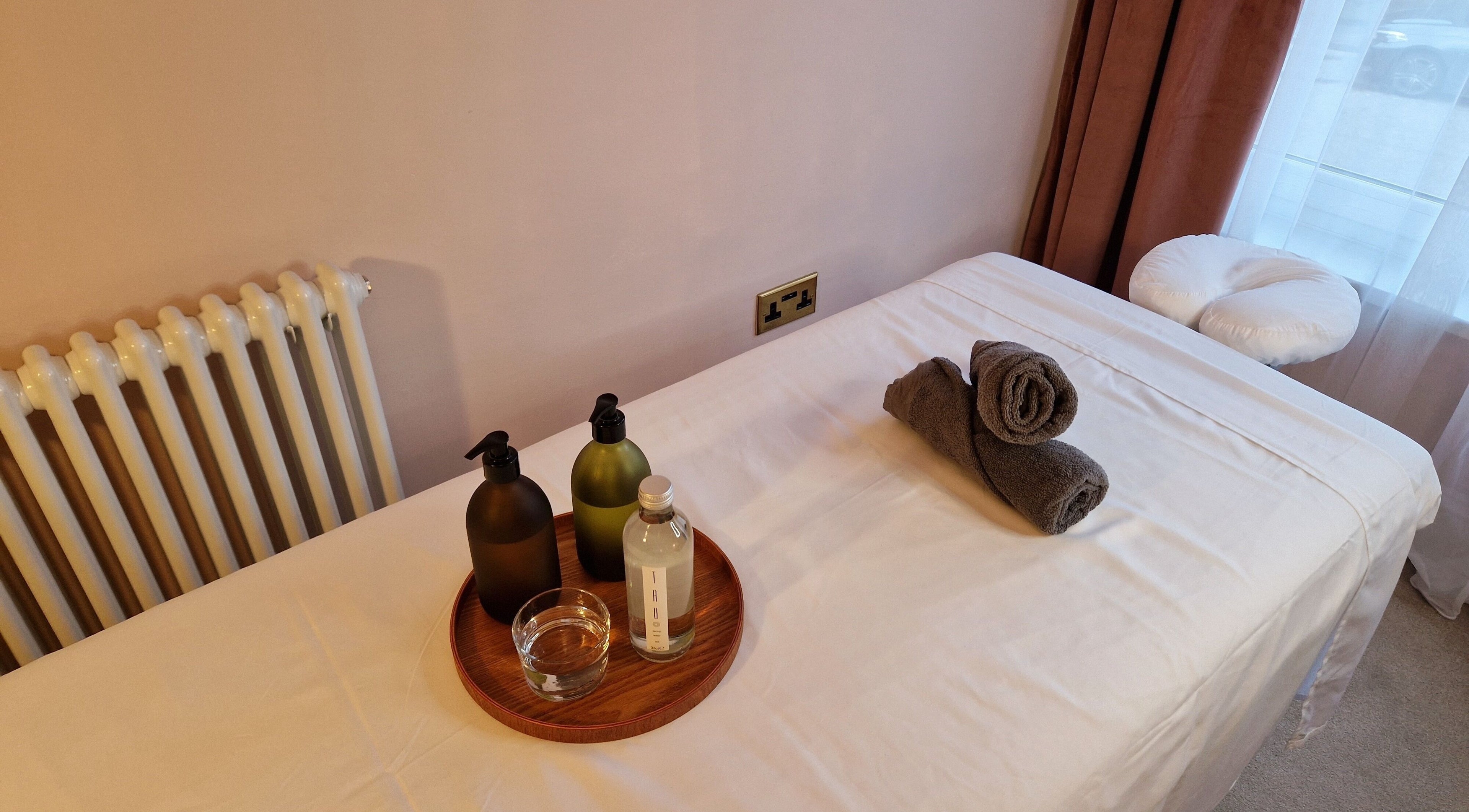 Massage table setup at Ailennyn | Rekindle Mobile Massage Therapy in Cardiff, Wales, GB with oils and towels.