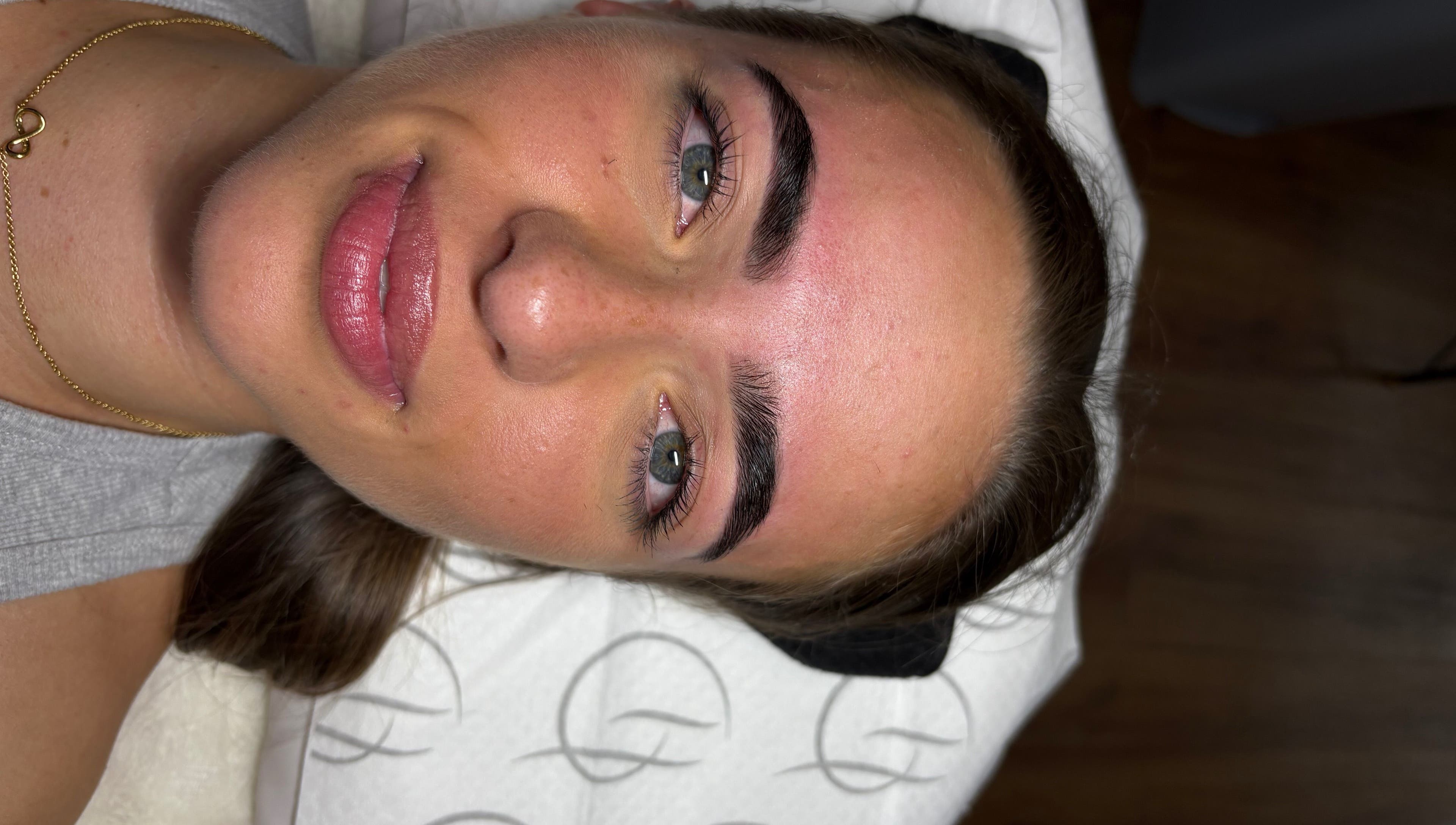 Close-up of a woman's perfectly groomed eyebrows after treatment at The Glow Up Club, Brough, England, GB.