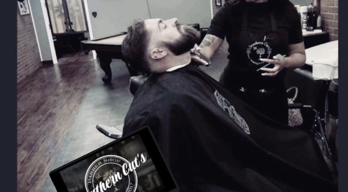 Stylist grooming client at Carlisha\SHECUTS in Irmo, South Carolina, US, showcasing expert barbering.