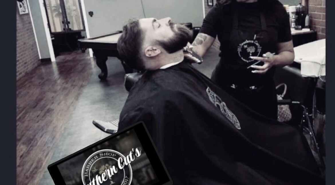 Stylist grooming client at Carlisha\SHECUTS in Irmo, South Carolina, US, showcasing expert barbering.