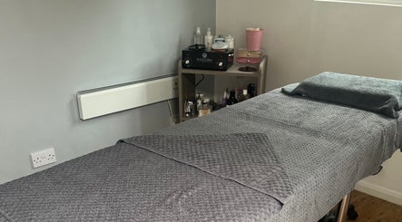 Cozy treatment room at Joy in Beauty, Griggs Green, England, with a plush massage bed.
