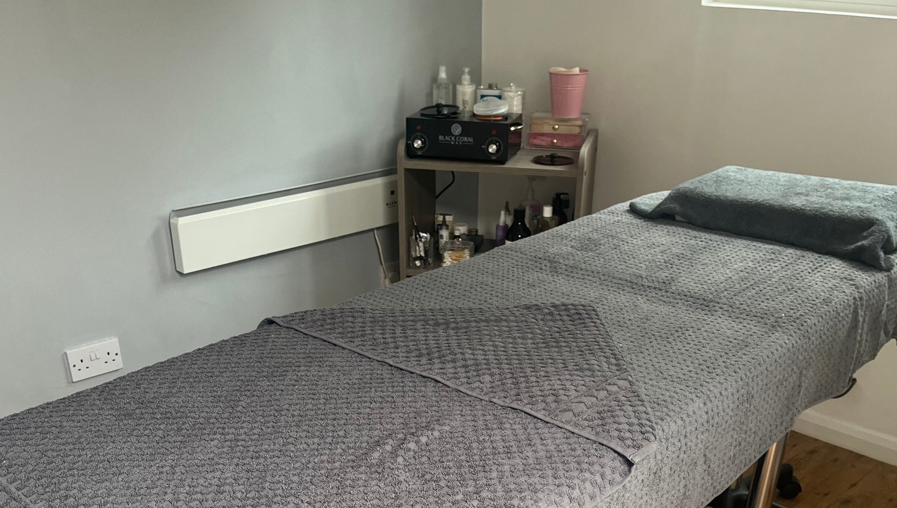 Relaxing treatment room at Joy in Beauty, Griggs Green, England, GB, featuring a plush massage table.