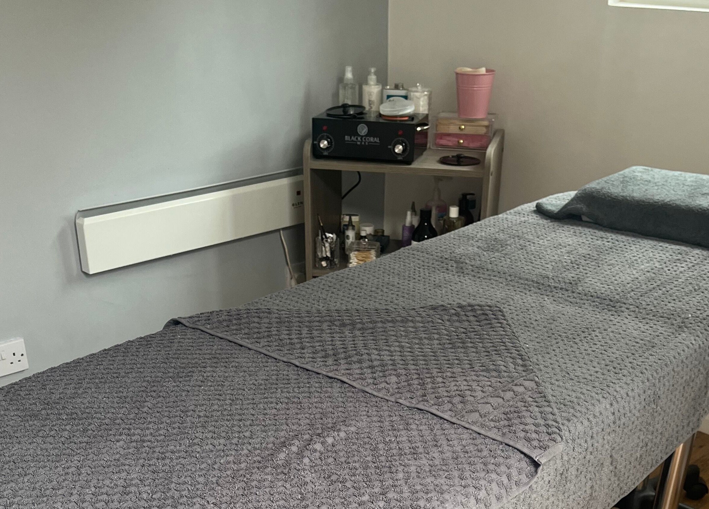 Relaxing treatment room at Joy in Beauty, Griggs Green, England, GB, featuring a plush massage table.