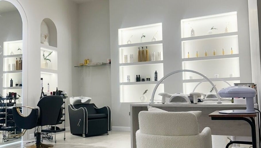 Stylish interior of Perla Beauty Lounge in Ras Al Khaimah, AE, showcasing modern salon chairs and shelves.