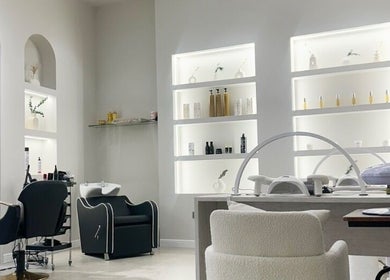 Stylish interior of Perla Beauty Lounge in Ras Al Khaimah, AE, showcasing modern salon chairs and shelves.