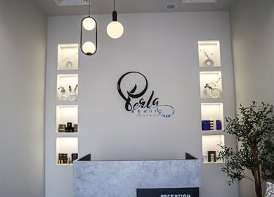 Reception at Perla Beauty Lounge, Ras Al Khaimah, AE with illuminated shelving and modern decor.
