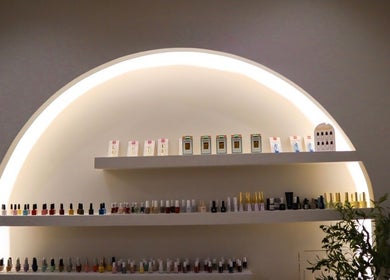 Shelves of beauty products at Perla Beauty Lounge, Ras Al Khaimah, AE, showcasing vibrant nail polishes.