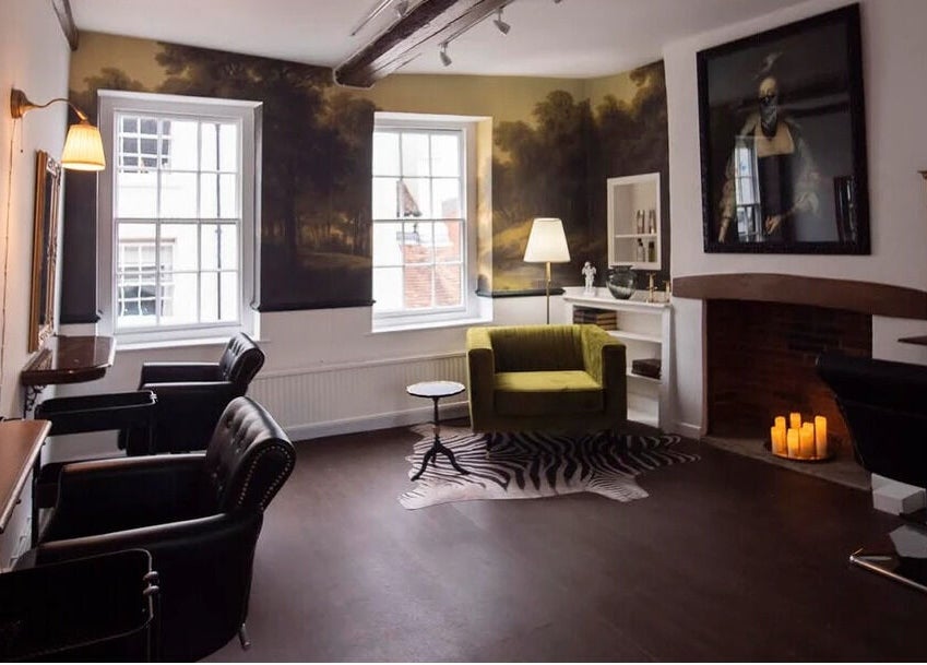 Chic and cozy salon space at Jack & the Wolfe, Lymington, England, GB, featuring stylish chairs and ambient lighting.