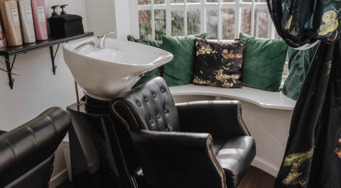 Elegant hair wash station at Jack & the Wolfe, Lymington, England, GB with plush seating and stylish decor.