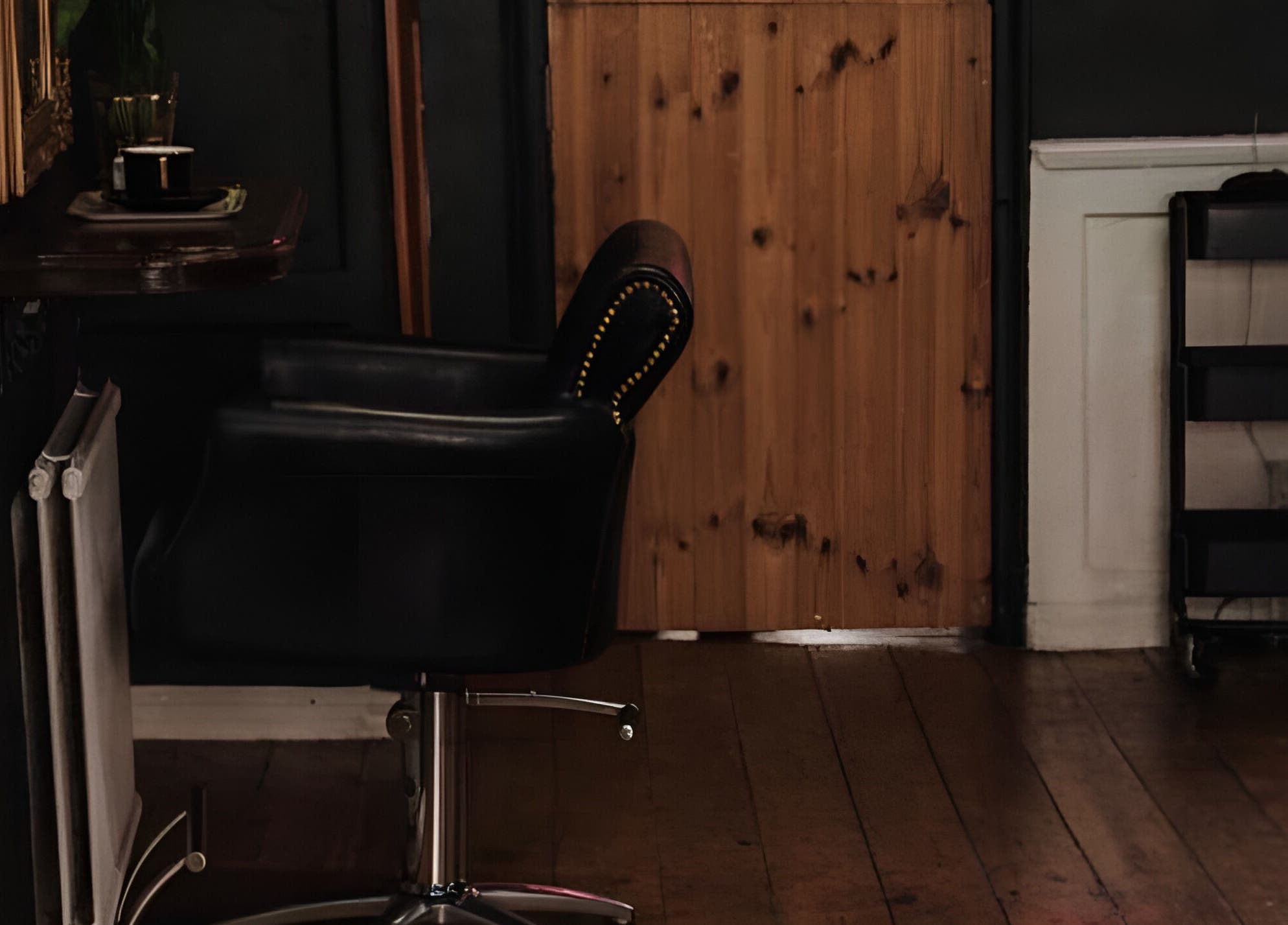 Elegant interior of Jack & the Wolfe, Lymington, England, GB, showcasing a stylish black salon chair.
