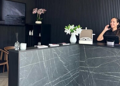 Reception area of William Foley Skin, Alderley Edge, England, GB with a smiling receptionist.