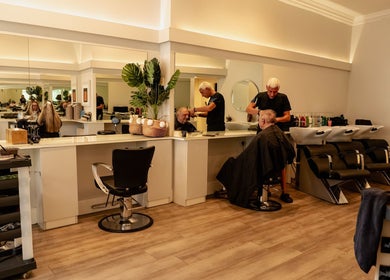 Stylish interior of David Masters Salon - St Margarets in Twickenham, England, GB with busy hairstylists.