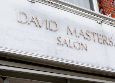 Signage of David Masters Salon - St Margarets in Twickenham, England, GB, displaying its elegant exterior.