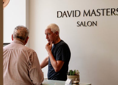 Two people conversing at the reception of David Masters Salon - St Margarets, Twickenham, England, GB.