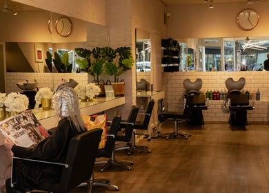 Inside view of David Masters Salon - Richmond Bridge in Twickenham, England, GB with modern decor and styling stations.
