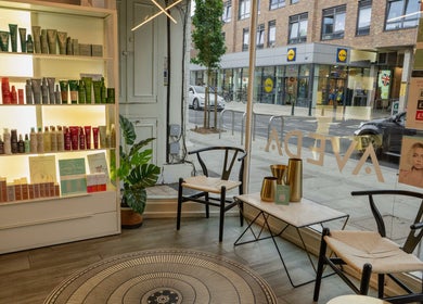 Cozy corner at David Masters Salon - Richmond Bridge, Twickenham, England, GB showcasing beauty products and seating.