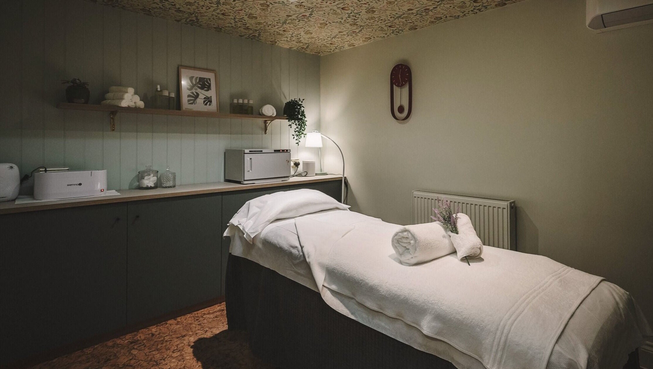 Massage room at Cecily Marlow in Marlow, England, GB featuring a cozy treatment bed and warm lighting.