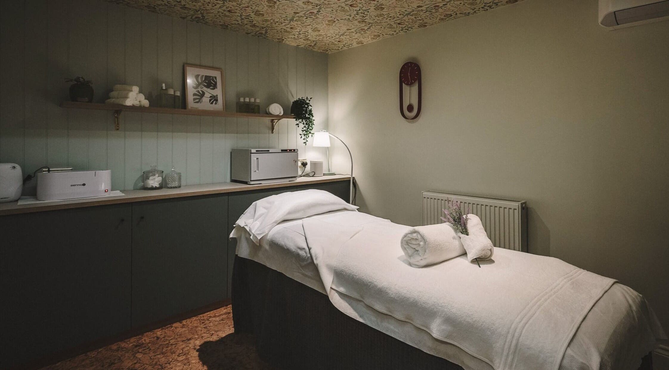 Massage room at Cecily Marlow in Marlow, England, GB featuring a cozy treatment bed and warm lighting.