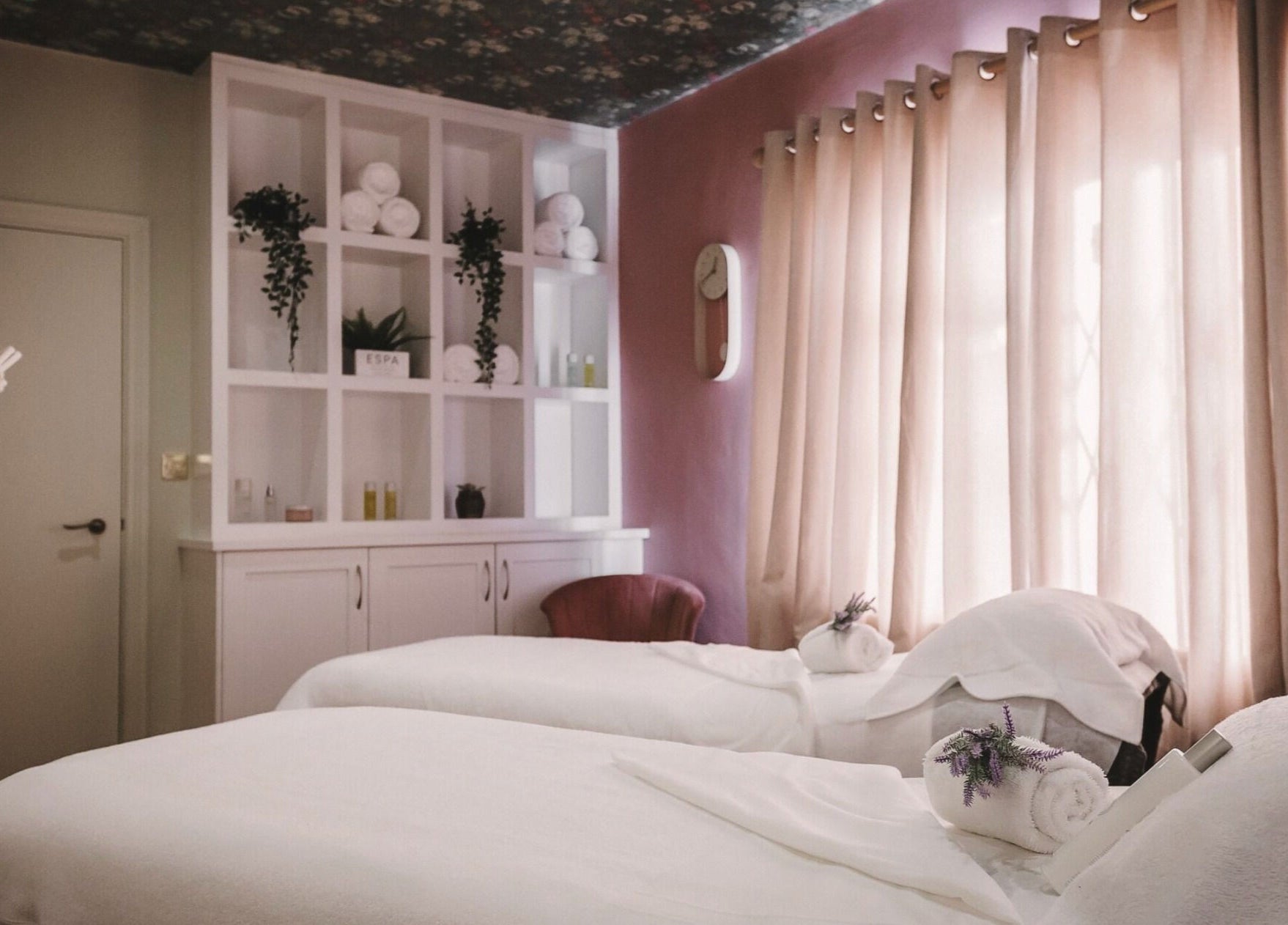 Cozy spa room at Cecily Marlow, Marlow, England, GB with two massage tables and soft lighting.