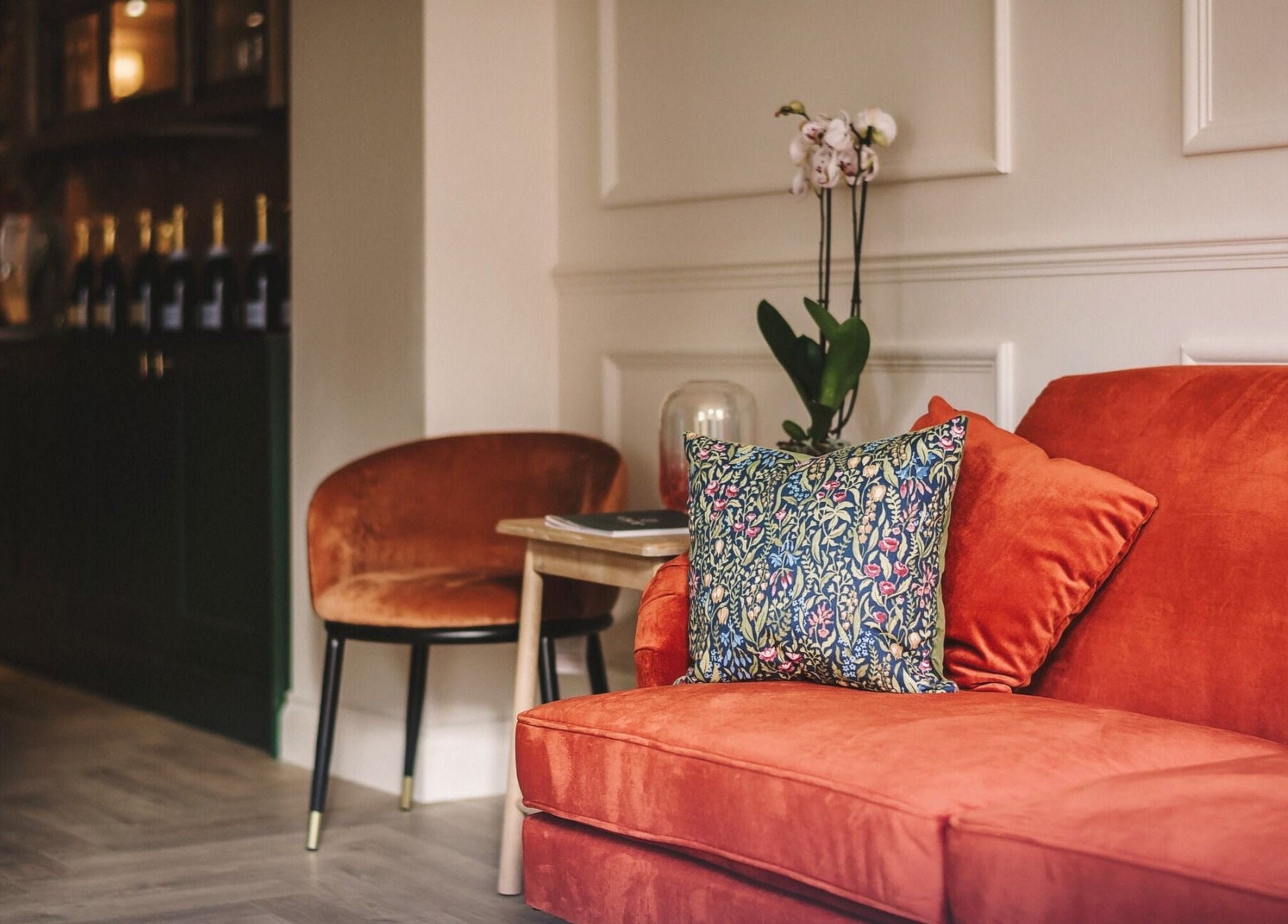 Elegant lounge at Cecily Marlow with orange sofa in Marlow, England, GB.