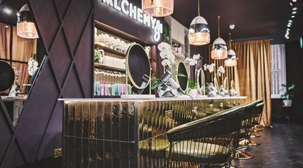 Elegant interior of Alchemy & I Berkhamsted salon in Berkhamsted, England with modern styling stations.