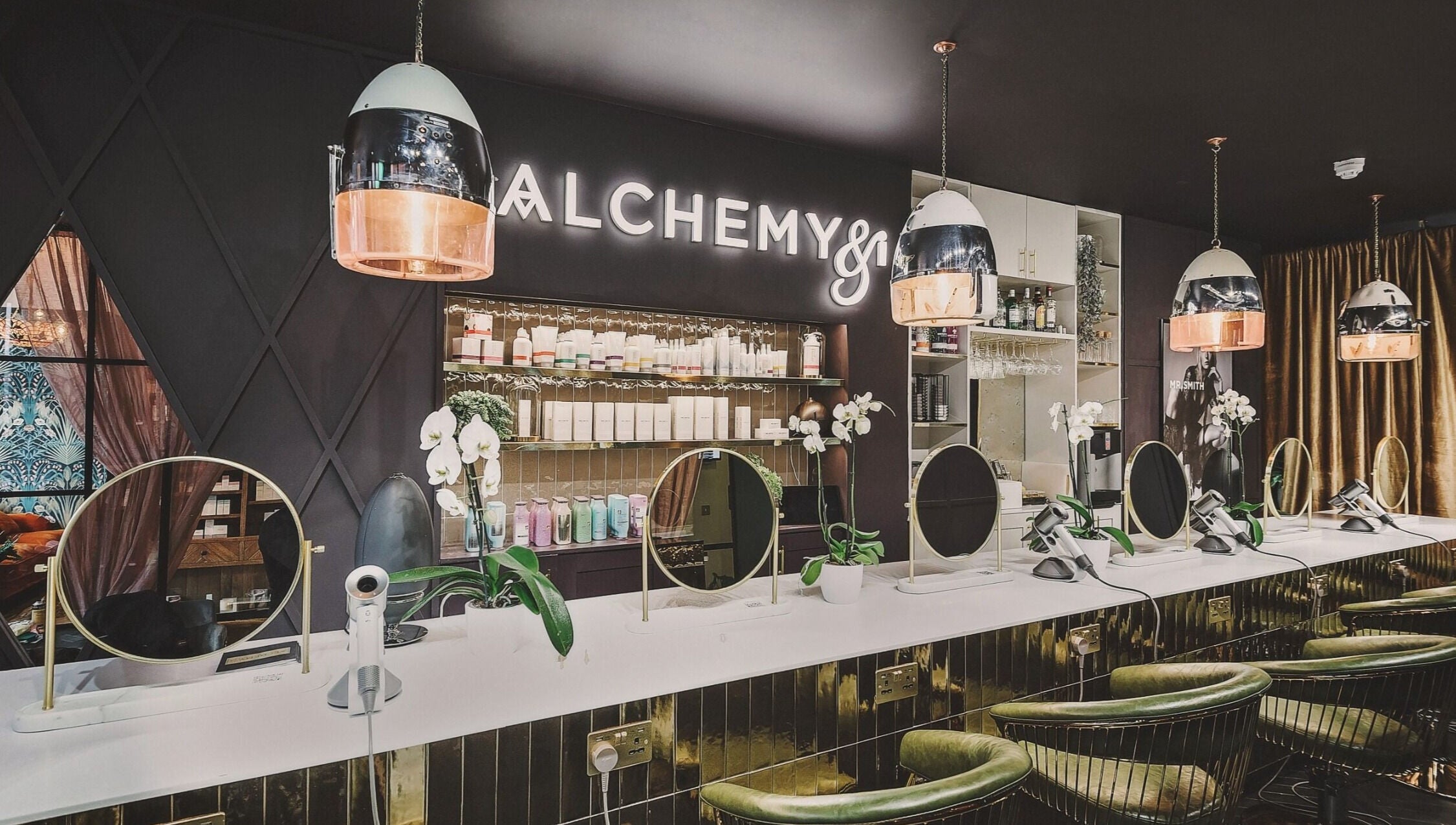 Modern beauty station at Alchemy & I, Berkhamsted, England, GB with elegant mirrors and stylish decor.