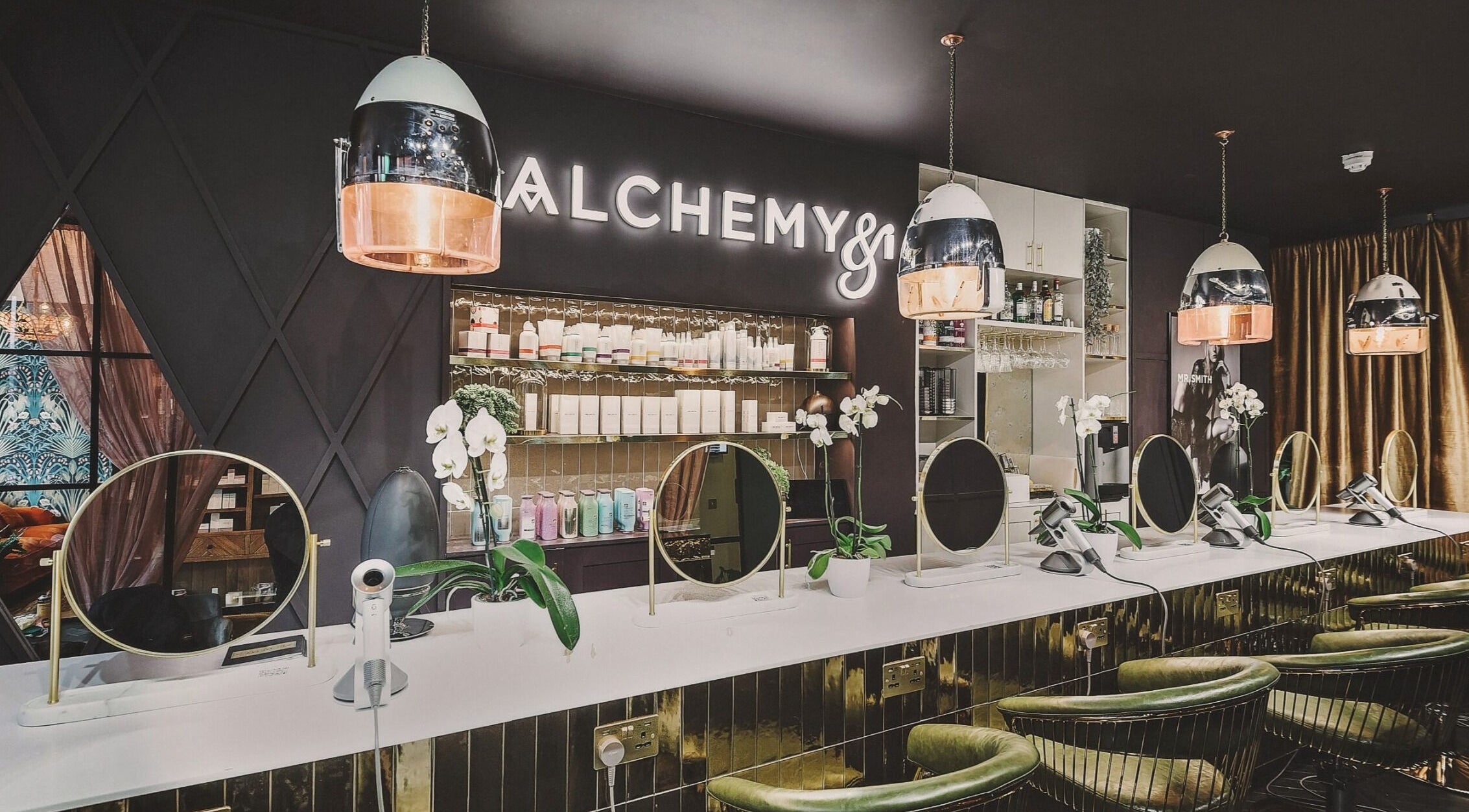 Modern beauty station at Alchemy & I, Berkhamsted, England, GB with elegant mirrors and stylish decor.