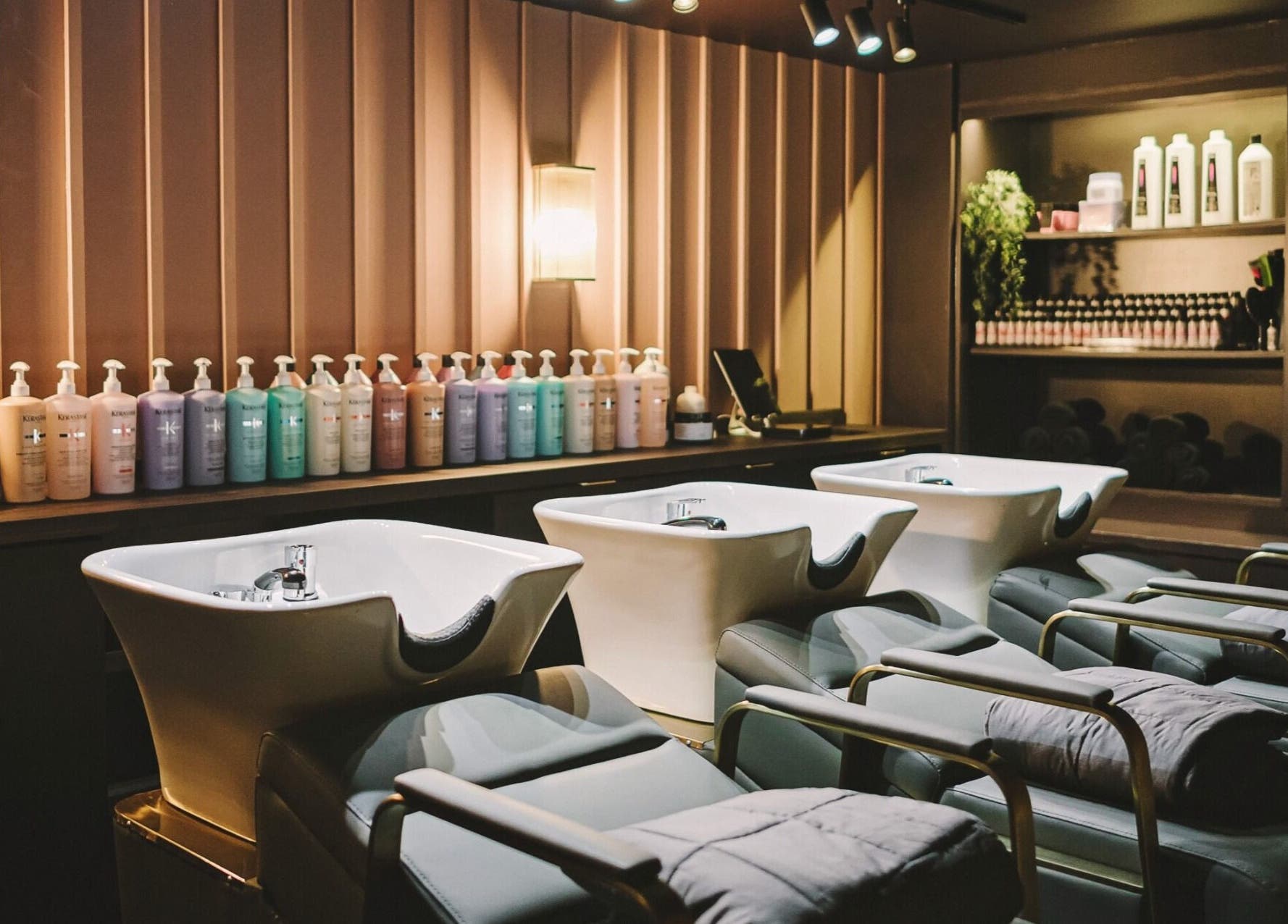 Elegant washing stations at Alchemy & I in Berkhamsted, England, GB, showcasing premium hair care products.