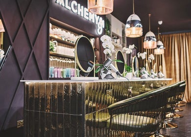 Luxurious interior of Alchemy & I salon in Berkhamsted, England, GB showcasing elegant styling stations.