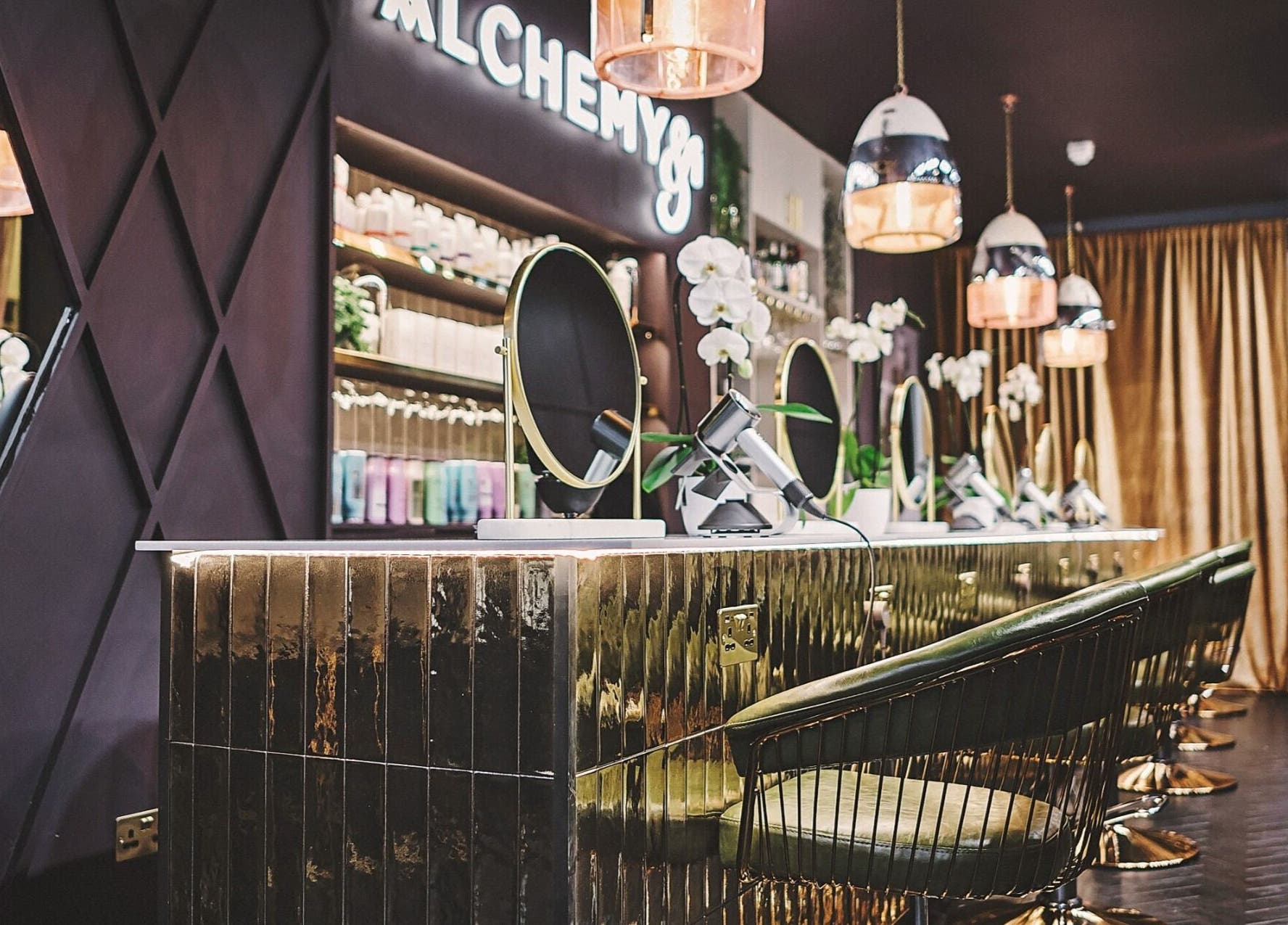 Luxurious interior of Alchemy & I salon in Berkhamsted, England, GB showcasing elegant styling stations.