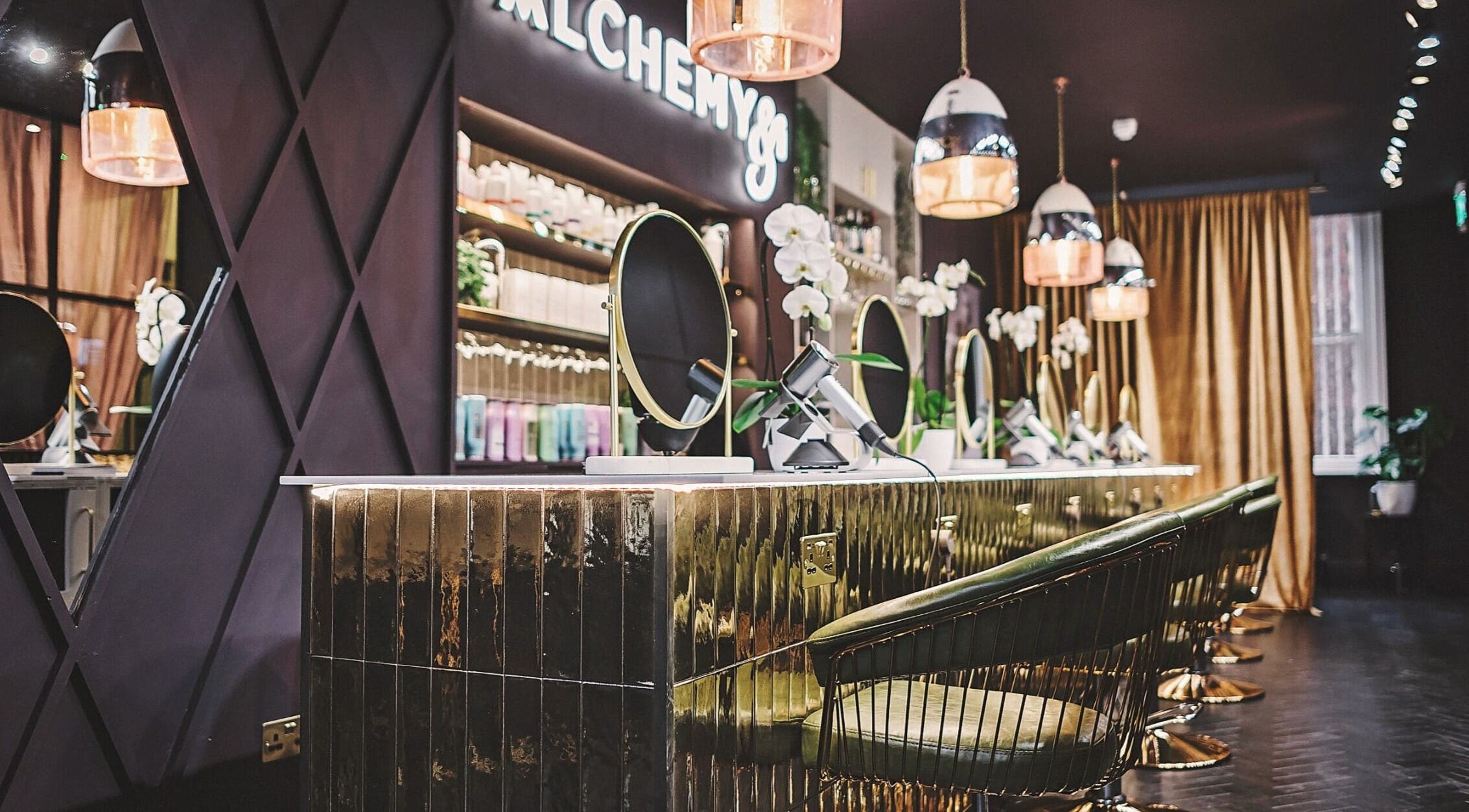 Luxurious interior of Alchemy & I salon in Berkhamsted, England, GB showcasing elegant styling stations.