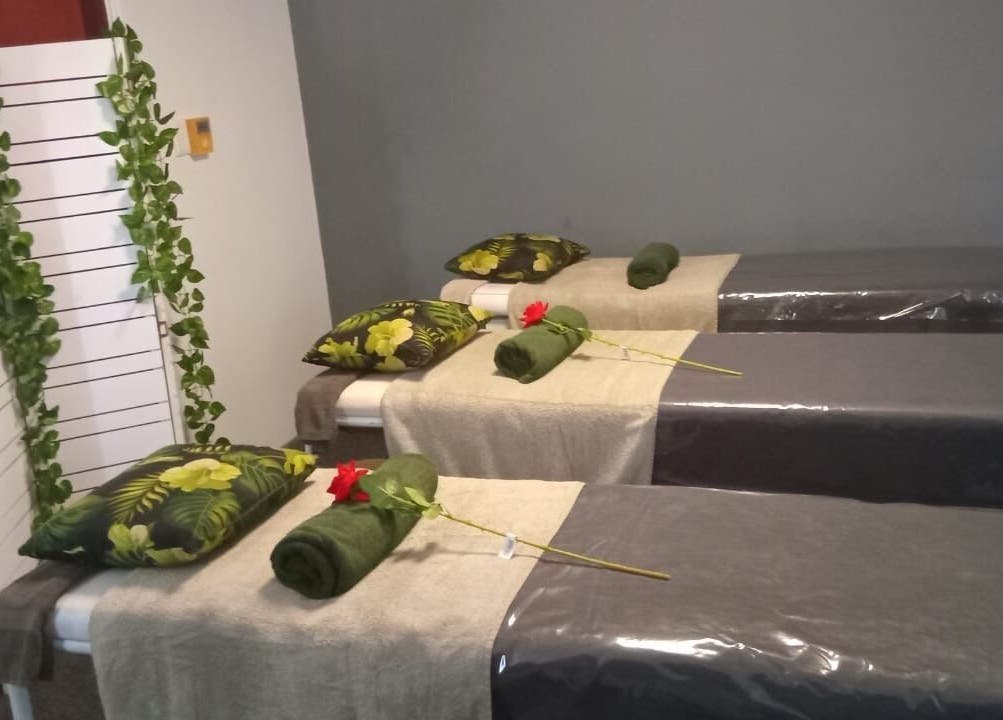 Relaxation beds at Ispa Aesthetics, Cape Town, Western Cape, ZA, with floral decor and soft hues.
