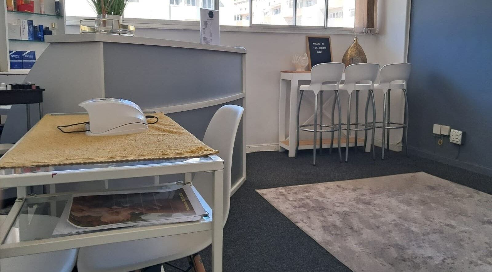 Modern, inviting reception at Ispa Aesthetics, Cape Town, Western Cape, ZA with sleek design and comfortable seating.