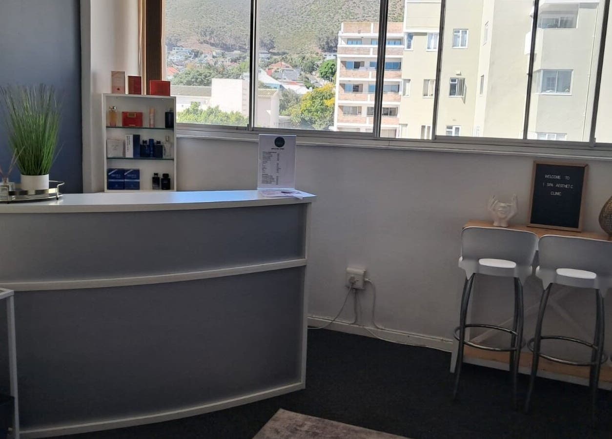 Modern reception at Ispa Aesthetics, Cape Town, Western Cape, ZA with a view of the city skyline.