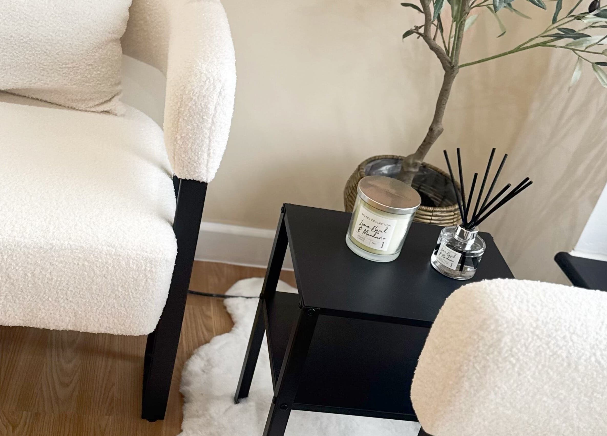 Cozy seating with white texture, scent candle, and plants at J9 Aesthetics, Harworth, England, GB.