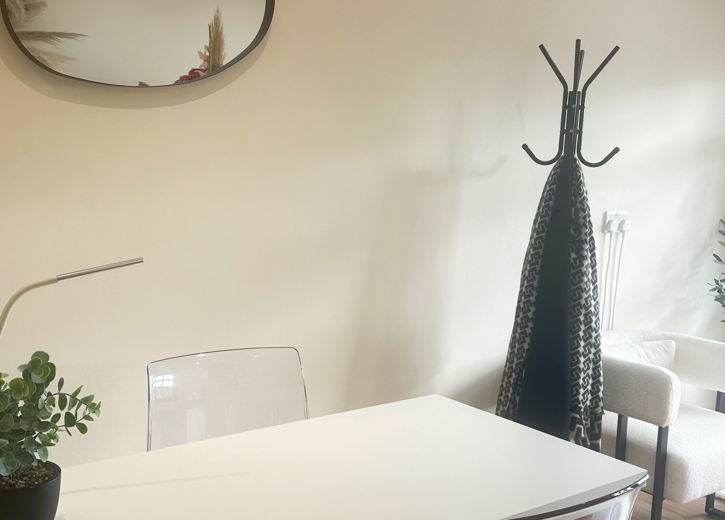 Cozy reception area at J9 Aesthetics in Harworth, England, GB with modern decor and lush greenery.