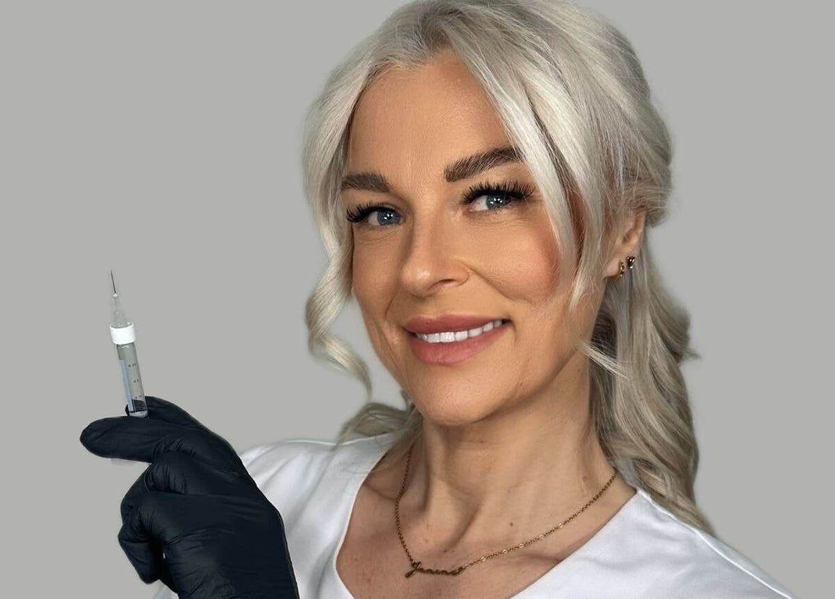 Aesthetician smiling with syringe at J9 Aesthetics, Harworth, England, GB, showcasing professional care.