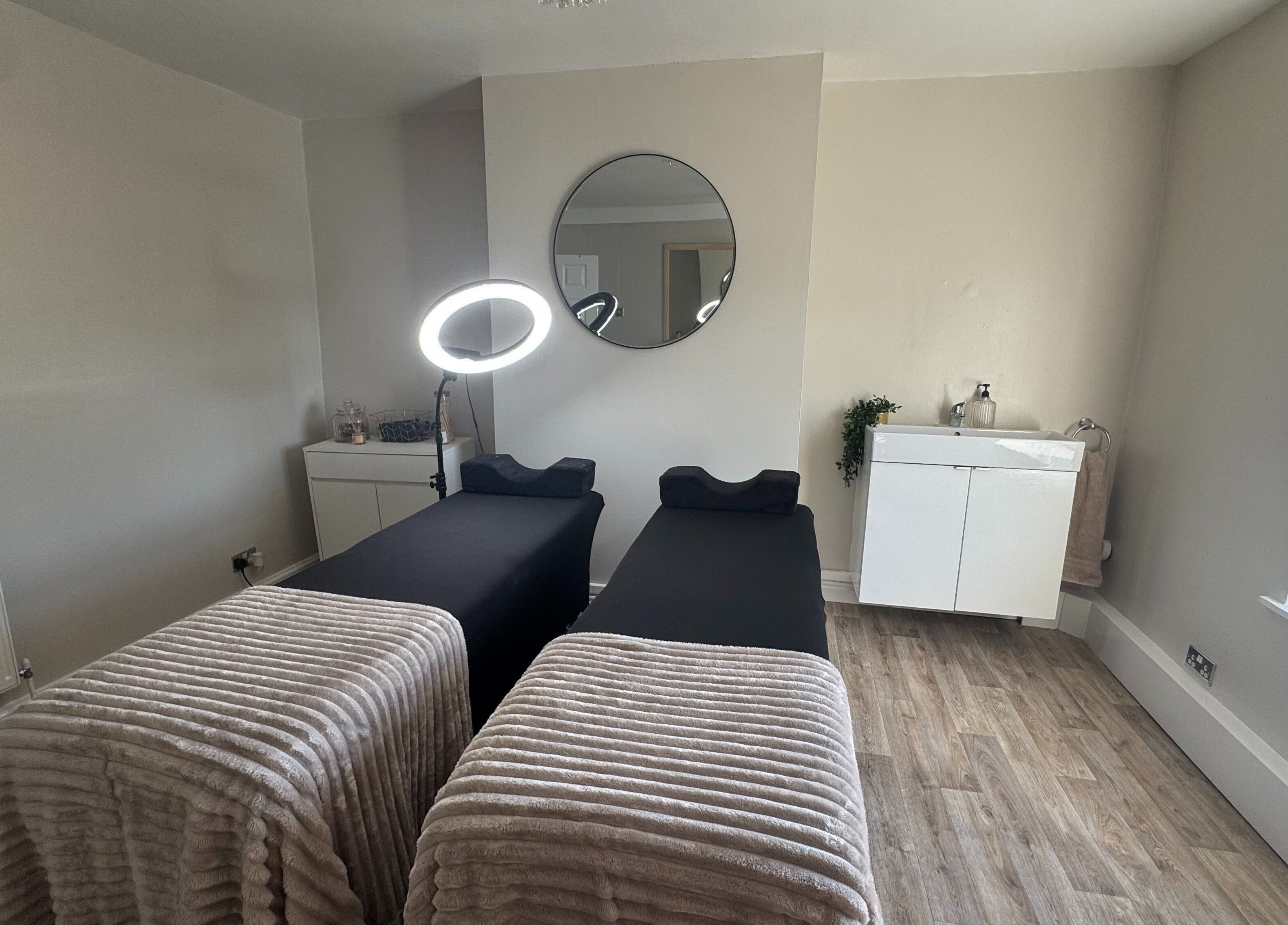 Tranquil treatment room at House Of Beauty, Failsworth, England, GB with dual massage beds and elegant decor.