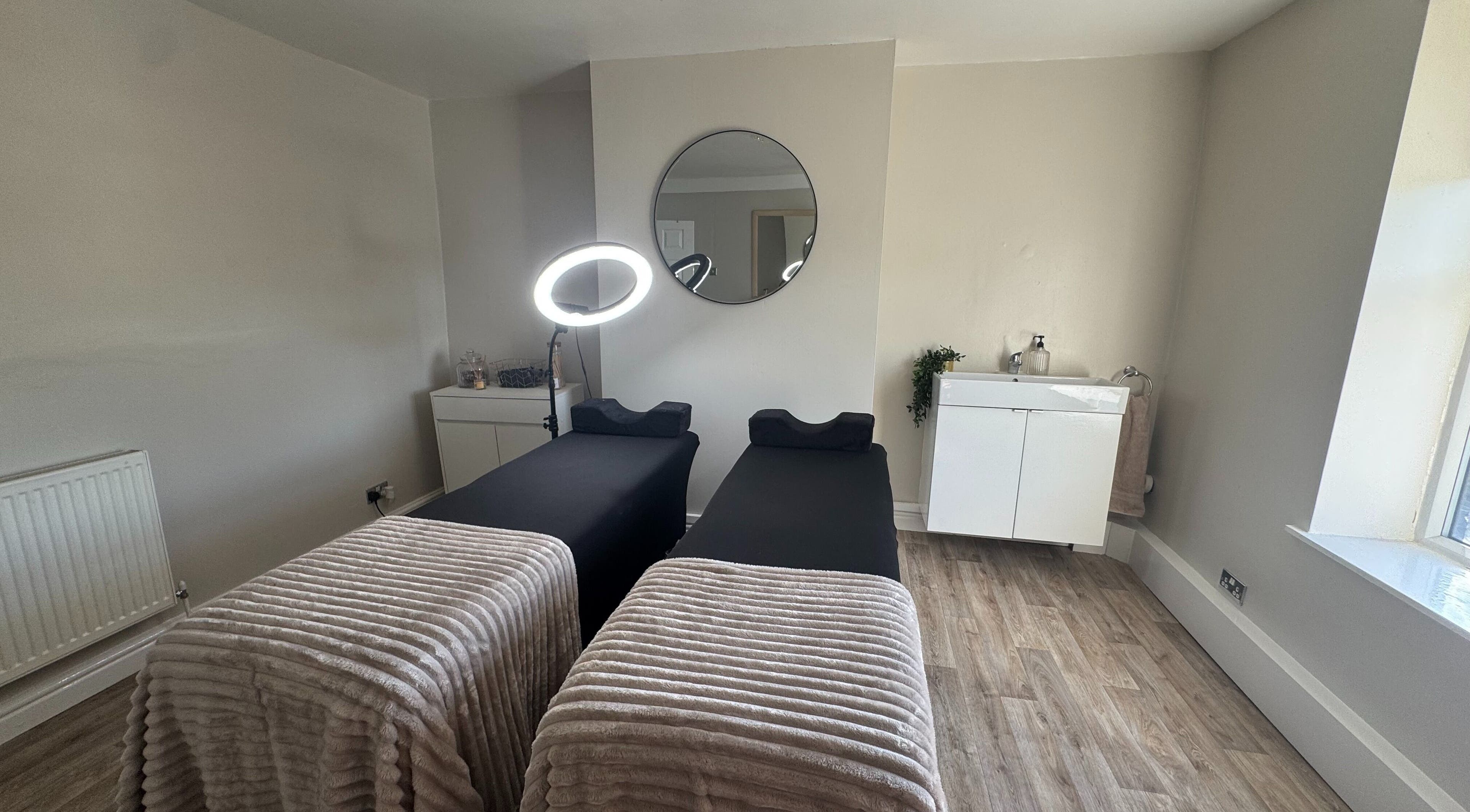 Tranquil treatment room at House Of Beauty, Failsworth, England, GB with dual massage beds and elegant decor.