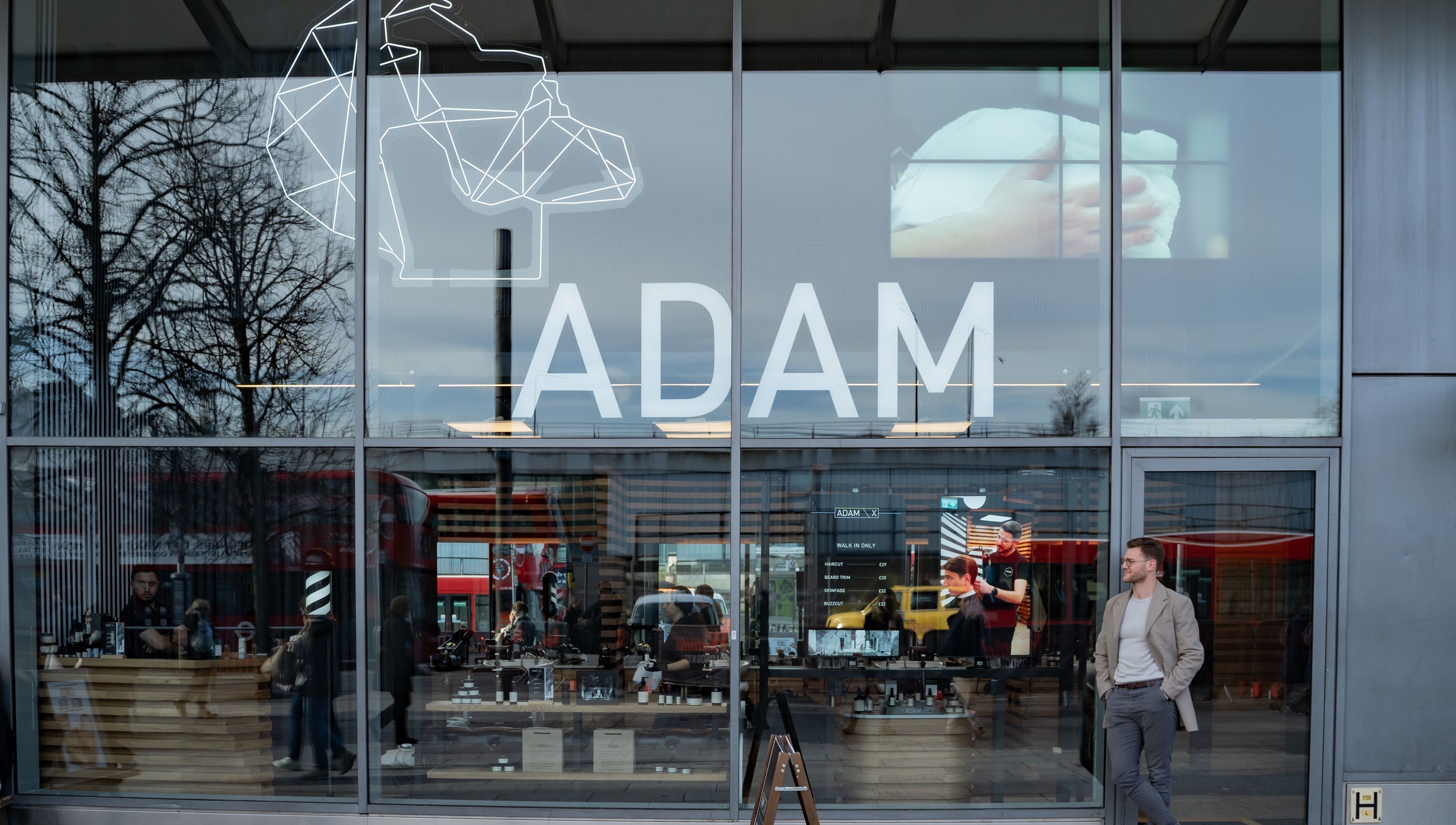 Exterior view of ADAM Grooming Atelier - Westfield London, showcasing the modern storefront in London, England, GB.