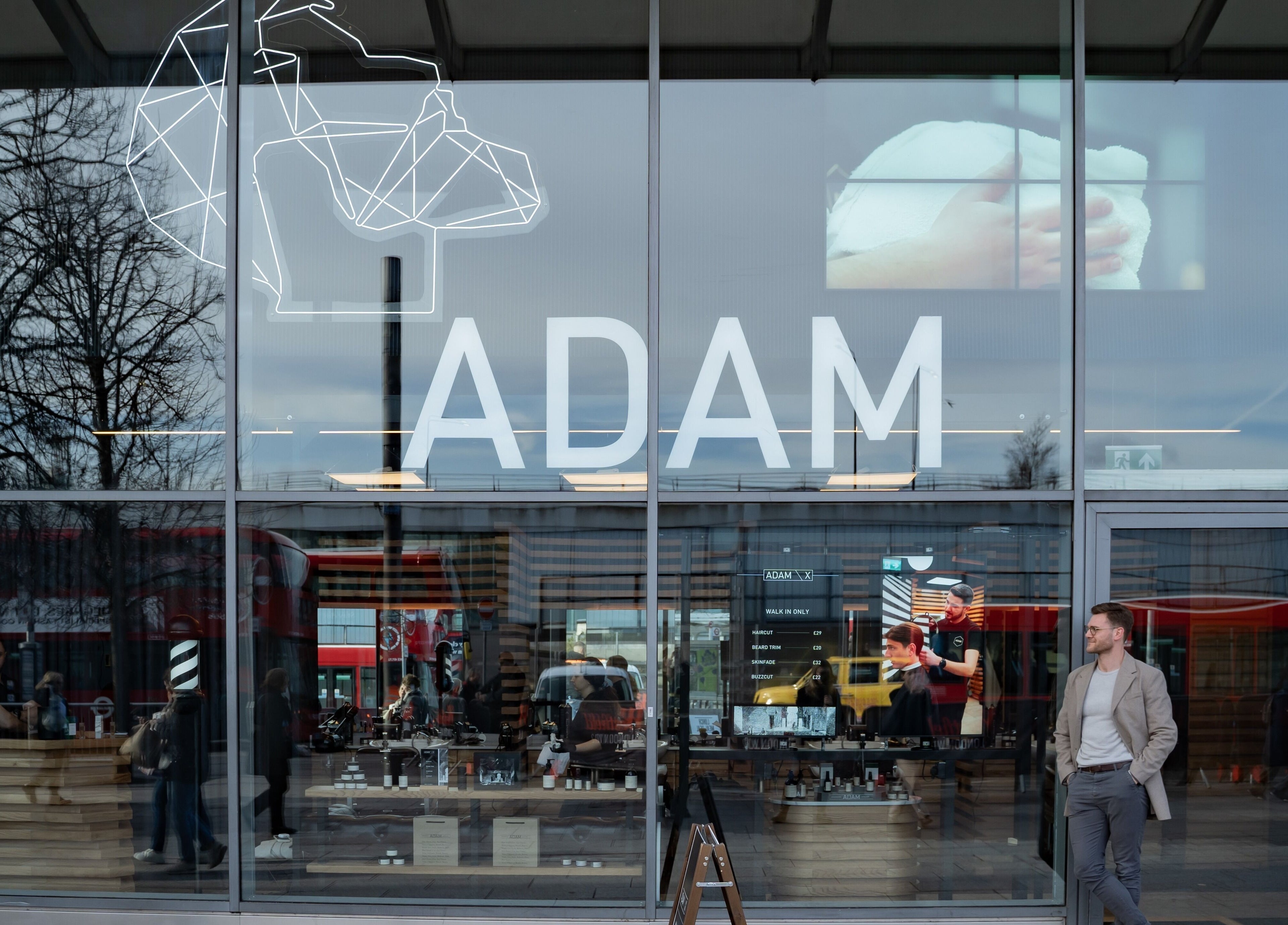 Exterior view of ADAM Grooming Atelier - Westfield London, showcasing the modern storefront in London, England, GB.
