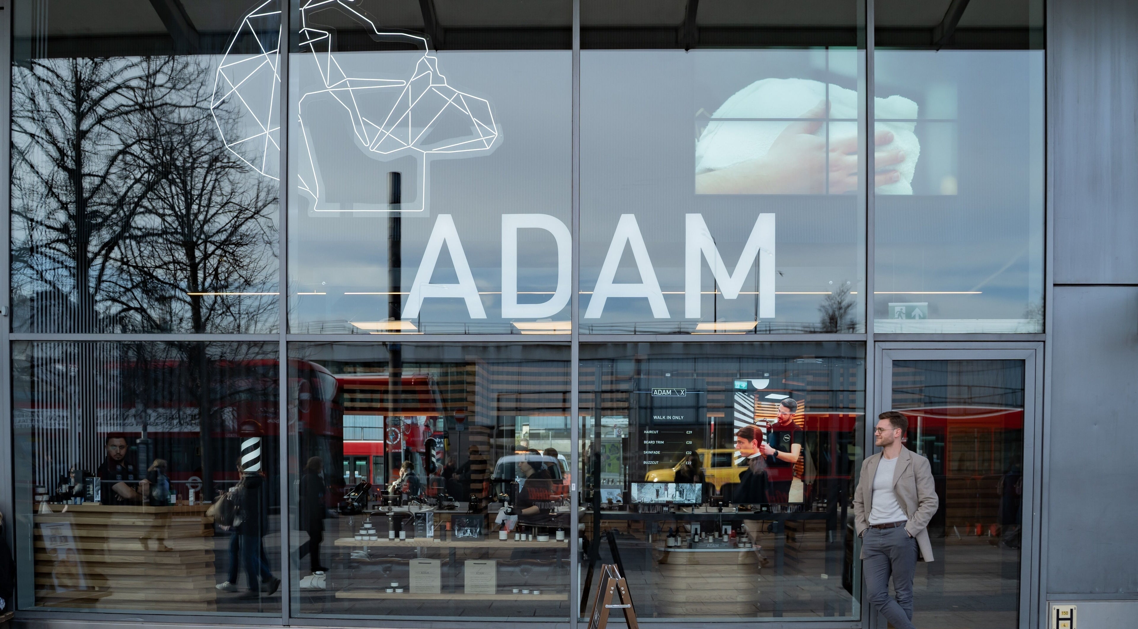 Exterior view of ADAM Grooming Atelier - Westfield London, showcasing the modern storefront in London, England, GB.
