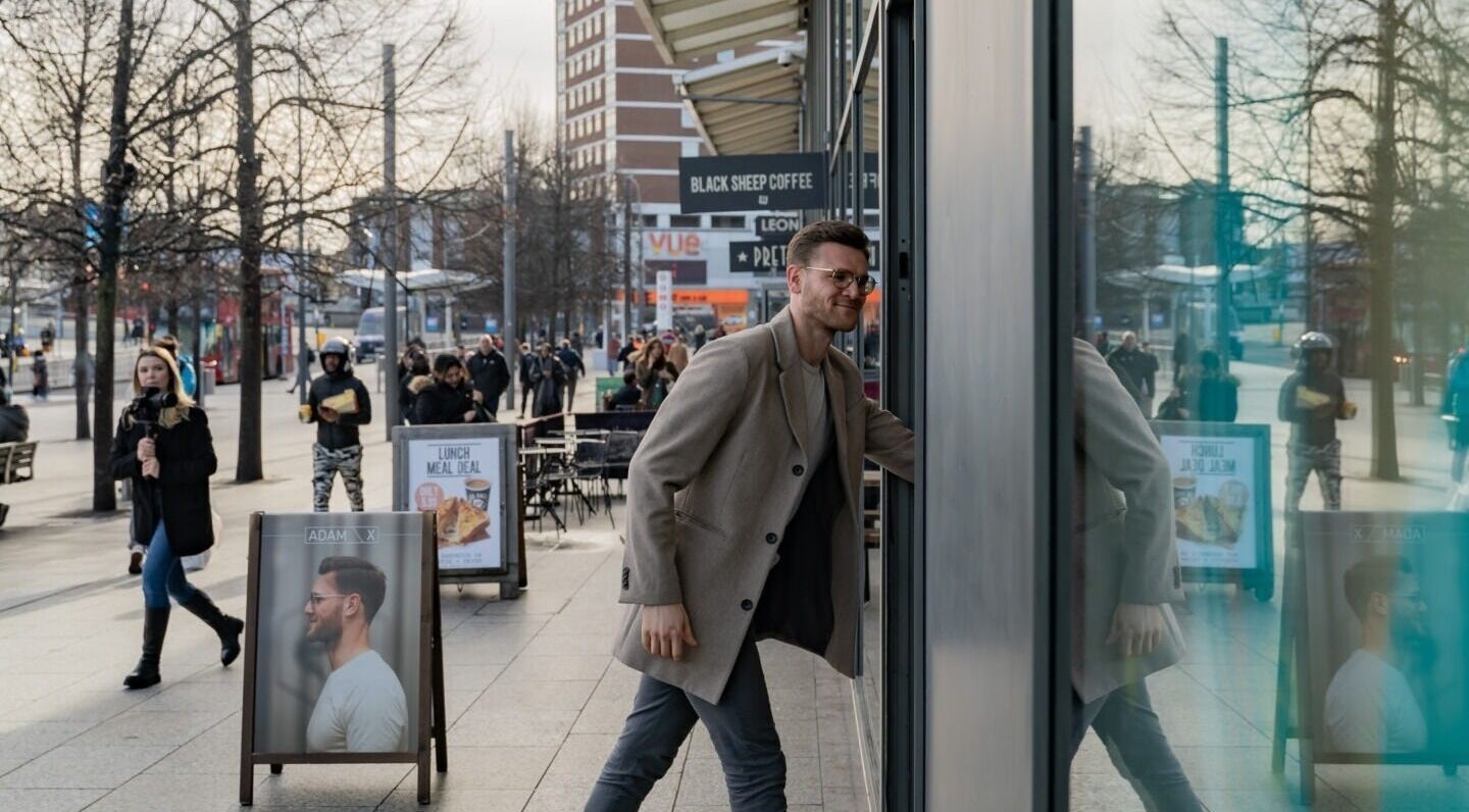 Man entering ADAM Grooming Atelier - Westfield London, located in London, England, GB.