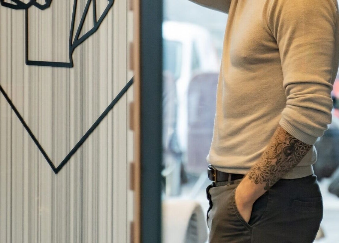 Man with tattoo enjoys his visit at ADAM Grooming Atelier - Westfield London, London, England, GB.